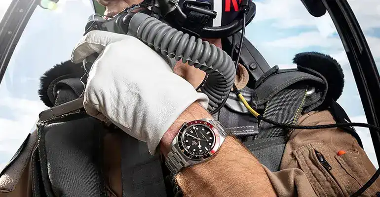 4. Shop all 177 x 228 Close-up of a pilot wearing a Tudor watch in an aircraft cockpit - Washington Watches