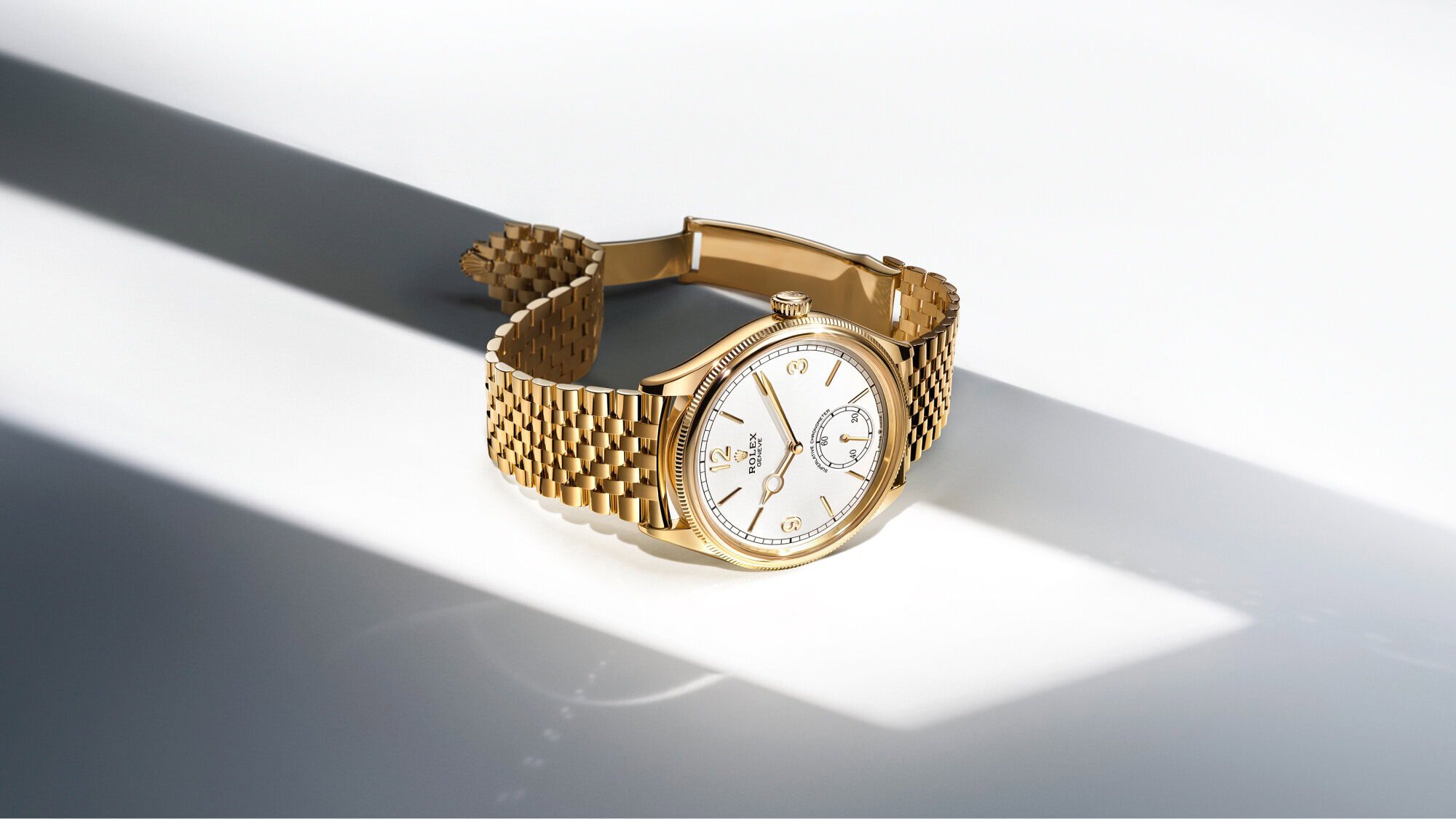Gold Rolex 1908 watch with white dial on a bright surface - Swee Cheong Watch